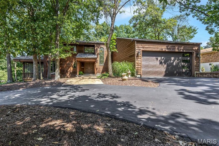 Tucked on a serene .75 acre lot in a quiet Sunset Hills enclave, 12795 Nanell Lane is an extraordinary 4BR + Den, 3.5BA home offering over 4,400 sqft of refined, light-filled living space. The remodeled main level is a showstopper, with new hardwood floors, soaring cathedral ceilings, & walls of windows that flood the home with natural light. The stunning designer kitchen boasts custom walnut cabinetry, quartz countertops, Bosch appliances, a built-in island beverage fridge, & dual dishwashers—perfect for entertaining. A spacious butler’s pantry, coffee station, and living room wet bar offer luxury and convenience, while two stone wood burning fireplaces and a custom water feature create a spa-like ambiance throughout. Outdoor living seamlessly blends with the interior via an expansive wraparound deck—partially screened for comfort—and a private deck off the primary suite. The updated primary also features a luxe bath and an enhanced walk-in closet with a custom swivel mirror. Upstairs, a guest suite offers privacy with its own full bath, while a new laundry room adds daily ease. The walkout lower level features a generous family room with wood-burning fireplace, a game room, and a screened patio for year-round enjoyment. A tandem 3-car garage, circle drive, generous parking, new roof, central vac, & access to top-rated Lindbergh Schools enhance this remarkable home—ideally located minutes from Tapawingo National Golf Club, Grant’s Trail, Laumeier Sculpture Park, and 44/270.