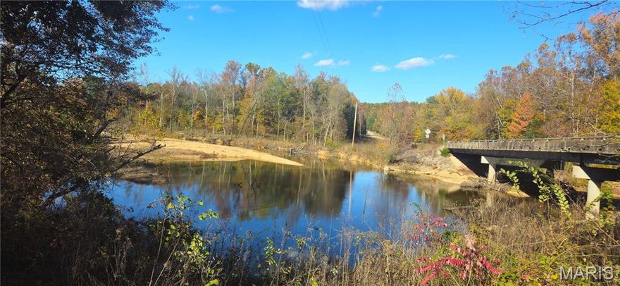 Discover the freedom of wide-open space where you can ride horses or ATVs on miles of trails, fish in your private stocked pond, or unwind beside a clear rock-bottom creek—all tucked just off pavement with complete privacy and no homes in sight.  This energy efficient, 2-story home has hardwood floors throughout, 2 large bedrooms upstairs, primary bedroom and bath on main level, lots of windows, large kitchen w/quartz countertops. Mudroom w/ 1/2 bath!  The 24x 32 Great Room has soaring ceilings & is connected to the home by a breezeway; use as a bonus living space, garage, or workshop. Full basement w/safe room. 64x84 custom horse barn w/runs; 9 stalls, 3 foaling stalls-each w/elec drops, sep. tack & feed rooms, LED lighting; 40x84 indoor riding arena, perfect for year-round training. Pastures securely fenced w/woven wire & electric. Separate pasture w/10x20 loafing shed. 3 Ritchie waterers & 9 winter hydrants.  24x40 shop/garage, & 80 x 24 6-bay equipment shed offer tons of storage space. Private well & septic.  Beautiful home, LIVE water-Big Creek, Custom Barn, Pastures, Outbuildings, Pond, Spring, Woods, & Trails, The Ultimate in country living—an hour to Poplar Bluff or Farmington & 20 minutes to Fredericktown.  Offered with 100 acres m/l with additional land available.