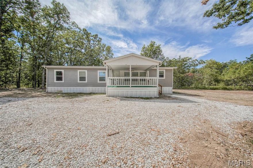 Enjoy country living just minutes from Rolla with this beautifully updated 3-bedroom, 2-bathroom manufactured home on approximately 3.65 peaceful acres surrounded by mature trees. A brand-new well and septic add peace of mind, while the welcoming covered front porch sets the tone for the stylish interior. Step inside to an open-concept living, dining, and kitchen area featuring luxury vinyl plank flooring and cozy shiplap accents. The kitchen is a showstopper with its huge butcher block island with seating, sliding barn-door pantry, built-in coffee bar with open shelving, apron-front farmhouse sink, and stainless steel vent hood. The primary suite is a true retreat, complete with a spacious en-suite behind a barn door, dual vanities, and a step-in shower. Additional highlights include carpeted bedrooms, a convenient laundry room with access to the back porch, and plenty of outdoor space to enjoy the private setting. Don't let this opportunity pass you by.  Schedule your private tour today!