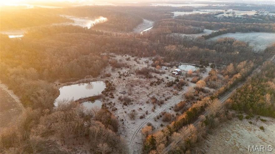 Here is an opportunity you don’t want to miss! This 33±-acre property located just 3 miles north of Perry, Missouri, offers a rare chance to own a beautiful recreational tract that touches part of Mark Twain Lake. Whether you are looking for a private weekend getaway, a hunting retreat, or a place to enjoy the outdoors with family and friends, this property has a lot to offer.

The farm features four stocked ponds that provide great fishing opportunities along with scenic views throughout the property. A cabin sits on the property and is already serviced with both water and electricity, giving you a comfortable base camp for relaxing weekends at the lake or extended stays in the country.

A well-established trail system winds through the mature hardwood timber, making it easy to explore the entire property. The trails lead to a scenic overlook where you can take in views of part of Mark Twain Lake, creating a peaceful setting that truly highlights what this property has to offer.

Wildlife is abundant throughout the farm, including deer, turkey, and a variety of other small game that call this part of Missouri home. With its combination of timber, water sources, and seclusion, the habitat provides excellent hunting and wildlife-viewing opportunities.

If spending time on the water is important to you, you will appreciate the quick and convenient access to multiple nearby boat ramps at Mark Twain Lake. Whether you enjoy fishing, boating, or simply spending a day on the water with family and friends, the location of this property makes it incredibly easy to enjoy everything the lake has to offer. Properties with this combination of acreage, water features, lake access, and utilities already in place do not become available often in this area.