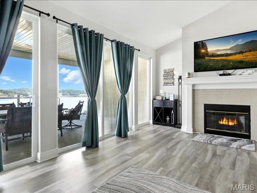 Wake up to breathtaking lake views in this spacious top-floor condo located just steps from the elevator. The open-concept living area with vaulted ceilings creates an airy, inviting space perfect for relaxing or entertaining after a day on the water. The large primary suite is a true retreat, featuring a jetted tub, walk-in shower, and private access to the oversized lake-view deck—the perfect place to enjoy your morning coffee or evening sunsets. Two additional bedroom suites provide plenty of space and privacy for family or guests, plus a convenient hallway half bath. The bright kitchen offers abundant cabinetry and solid-surface countertops, making meal prep and hosting easy.  Plus!!! Condo comes partially furnished!  Included with the property is a 12 x 32 boat slip, so you’re always ready for a day on the lake. And when you’re ready for great food, live music, and fun, Captain Ron’s is just across the water! Whether you're looking for a weekend getaway, investment property, or full-time lake living, this condo delivers the perfect lake lifestyle.