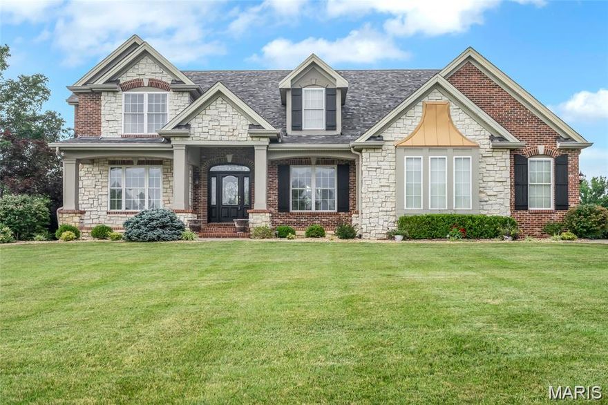 Discover the perfect blend of space, style, and serenity in this exceptional 1.5-story home with a 3-car garage, set on a picturesque 3.88-acre level lot offering privacy and endless possibilities. Major updates provide peace of mind, including a new roof (2024), upper-level furnace and A/C (2022), and a beautifully remodeled kitchen (2019) featuring granite countertops, stainless steel appliances, and modern finishes. A welcoming foyer opens to a dramatic two-story great room with soaring cathedral ceilings and floor-to-ceiling windows that flood the home with natural light while overlooking the scenic acreage. Rich wood floors and thoughtfully designed spaces create a home that feels both refined and inviting. The main level also features a private executive office with French doors and an additional sitting room, perfect for working from home or relaxing. The spacious main-level primary suite offers a peaceful retreat with dual walk-in closets and a luxurious bath featuring adult-height double vanities and a soaking tub. The finished lower level provides additional living and recreation space, including a custom bar with generous seating, pool table area, exercise room and flex room. Outdoor living is just as impressive with a covered patio perfect for evening gatherings overlooking the peaceful landscape. Additional features include Invisible pet fence with 2 collars, Front lawn irrigation system, 800-gallon propane tank (natural gas available for conversion), New carpet on the main level (3/2026), Fresh paint throughout most of the main level (3/2026). Located in the desirable Ft. Zumwalt School District and just minutes from major highways and everyday conveniences, this meticulously maintained property offers luxury, privacy, and flexibility rarely found in today’s market.