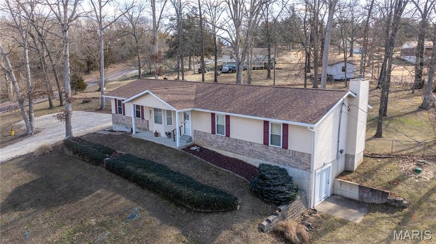 Beautiful ranch home set in the country on one and a half quiet acres. New architectural-shingle roof (2026 - $10k). New gutters with guards (2026 - $2k). New shutters and column wrapping (2026 - $2k).  New 19x15 wooden deck (2023 - $9k). New 50-gallon water heater (2026 - $2k) with warranty. New water softener (2025 - $3k). New septic risers and aerator (2026 - $3,400). Vaulted ceilings. Gourmet kitchen with stainless steel appliances. Main level laundry room. Open floor plan. Partially finished walk-out lower level with wood burning fireplace, rough-in bathroom, built-in shelving, and side patio. Exterior French doors with built-in blinds. Ceiling fans. Humidifier. Attic fan. Storm door. New sump pump (2025). Efficient vinyl windows. Level back yard with shade, fence, and wildlife. Large side yard to the south. Oversized two-car garage with door openers. Covered front porch. Premium brick elevation. Accessible features including ramp, grips, walk-in shower, and ADA toilet. Hillsboro school district. High speed internet available.