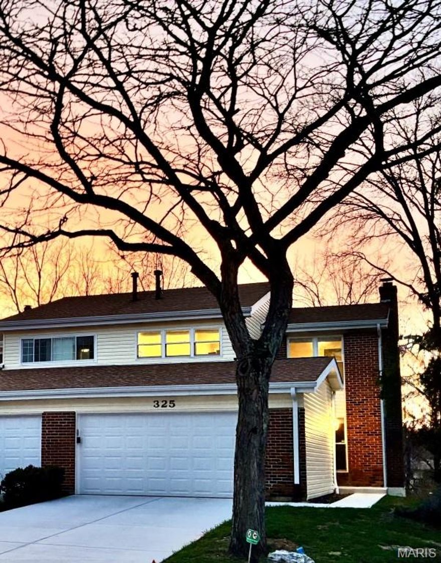 Bright end-unit townhome in the highly sought-after Rockwood School District, tucked on a quiet cul-de-sac with private wooded views. This 3 bedroom, 2.5 bath home offers an open, light-filled layout and a finished walkout basement with a cozy fireplace, perfect for additional living space, entertaining, or a home office. Enjoy stunning sunsets from the west-facing deck overlooking trees for added privacy. The home also features a spacious 2 car garage with loft storage and numerous updates, including a new roof, siding, gutters, concrete driveway, sidewalk, front porch and garage door (2025), plus new lower level flooring and fresh paint throughout (2026). Low HOA dues provide excellent value and include lawn care, snow removal, pool access, and more. Conveniently located within close distance to parks, trails, and nearby schools.