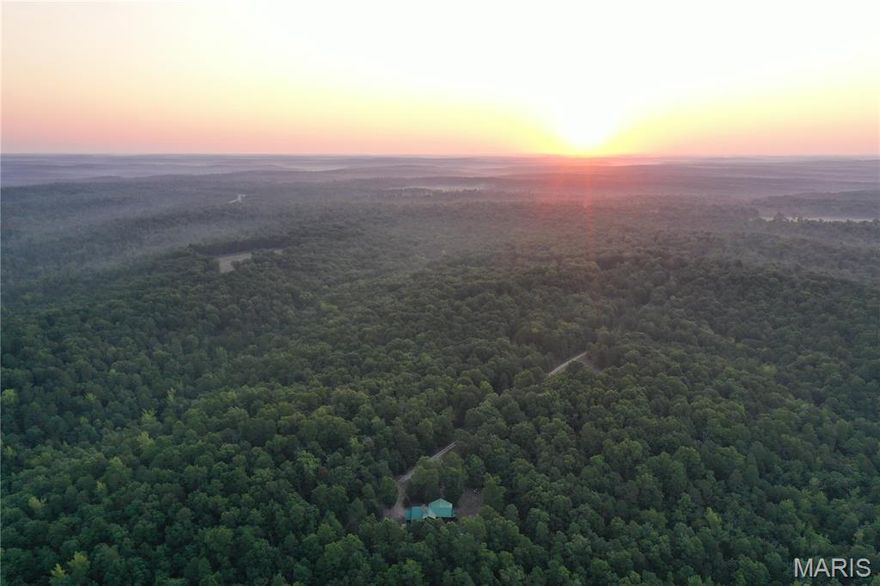 This turnkey hunting property is conveniently located between Doniphan and Poplar Bluff, along Ripley BB-2. This property consists of food plots, shooting houses, a pond, a fruit tree orchard and a year-round creek. The mix of food, water, and bedding area this property has attracts the abundant amount of wildlife in the area. The long, gated driveway takes you to the stunning custom lodge and provides the ultimate seclusion and privacy that the Ozarks have to offer. The lodge includes hickory cabinets, tons of custom wood finishes, big beautiful Ozark views, and a one-of-a-kind wood burning fireplace. The fireplace extends down to the basement, where you will find a second kitchen and a concrete vault/safe room. The concrete vault/safe room is the perfect place to store all your guns and valuables, and it makes for a great tornado/storm shelter. A metal shop and a second well are next to the fruit tree orchard adding additional storage for all your tools and equipment. If this is not enough acreage to get the job done on a mature whitetail or big tom turkey, Mark Twain National Forest and Missouri Conservation ground are nearby, making the hunting opportunities endless. If you are looking for a turnkey hunting property with a one-of-a-kind lodge, then this is a must-see! Call today to schedule your own private tour.