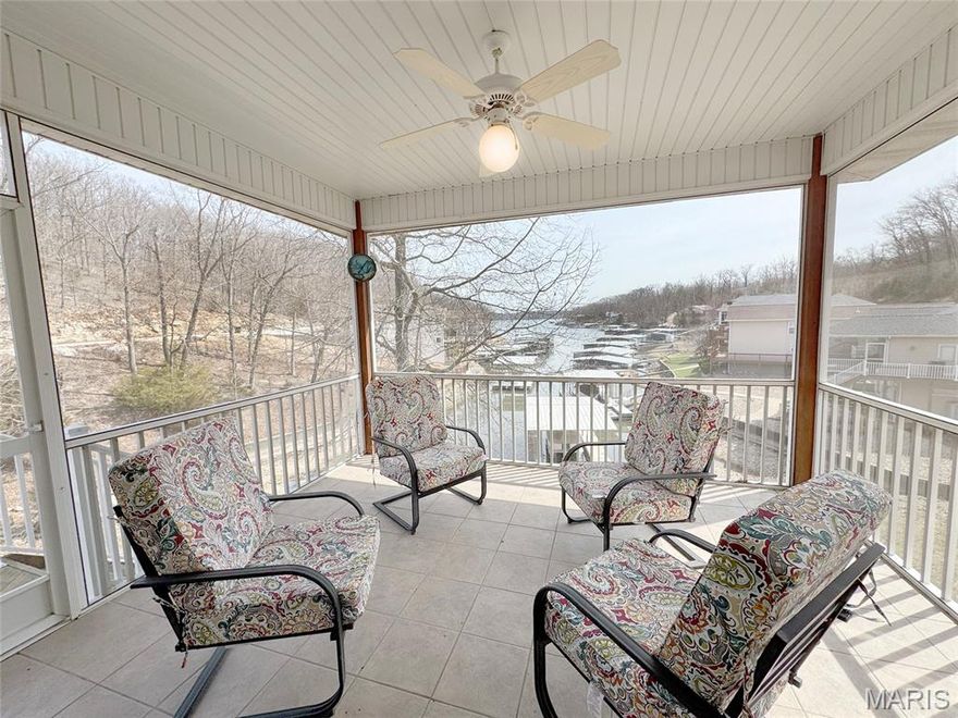 It's time to take a look at this one!!! Luxury lakefront living in quiet cove on 26mm! Relax across multiple outdoor spaces, w/ gorgeous main channel views—perfect for morning coffee, sunset cocktails, & watching Margaritaville's July 4th fireworks. Just minutes from the lake’s best waterfront restaurants & attractions, just hop on the boat & let the vacation begin. Inside, this stunning open-concept retreat welcomes you with a grand hearth room featuring cathedral ceilings, gas fireplace, & dramatic windows framing breathtaking water views. Kitchen offers stainless steel appliances, breakfast bar, + sunny breakfast nook that opens to the screened-in porch overlooking the lake. The main-floor primary suite is a private sanctuary w/ its own deck for even more outdoor enjoyment and boasts coffered ceilings, large walk-in closet, spa-inspired bath w/ double sinks + jetted tub & walk-in shower. Walk-out lower level features a spacious lakeside rec room, 3 more bedrooms including a primary-style suite w/ full bath & supersized walk-in closet. Fresh Paint. New Carpet. 12x30 dock, lift + Monark Seville 24' pontoon w/150 Yamaha outboard. Boat Ramp. Paved streets- NO GRAVEL. HOA covers water/sewer. Underground utilities. Level parking 4+ & attached garage. No STR allowed.