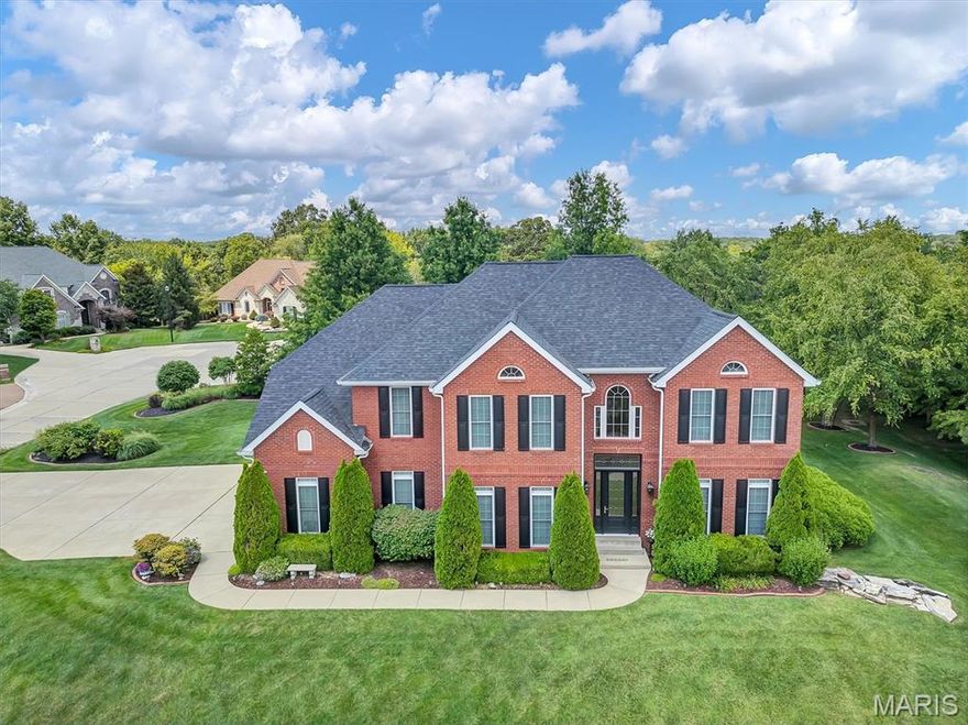 This Georgian-style home features an open layout with high ceilings, entry columns, and a bright great room. The kitchen includes ceramic floors, cherry cabinets, and a granite island, alongside breakfast and formal dining areas. Upstairs are four bedrooms, including a primary suite with two walk-in closets, sitting area, jetted tub, shower, and dual sinks; two bedrooms share a jack-and-jill bath. Laundry is conveniently located upstairs. The backyard has space for a pool. The lower level, with ceramic tile floors, offers finished rooms ideal for versatile uses, along with a full bath. Nestled in a beautiful subdivision, this home stands out for its exceptional quality & charm.