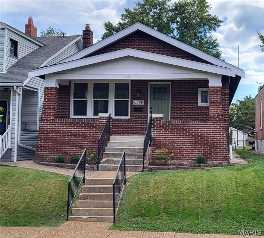 Experience the perfect combination of classic charm & modern updates in this brick bungalow located in the highly sought after Lindenwood Park neighborhood. Original hardwood floors and rich woodwork lead into an open & inviting main living/dining area. Updated kitchen with large breakfast bar, butcher block countertops, and brand-new stainless-steel appliances. Two bedrooms and an updated bathroom are complemented by a versatile rear addition with vaulted ceiling - perfect as a third bedroom, den, or office. Large double doors open to a new deck overlooking the huge backyard with an oversized parking pad accessible from the rear alley. The walk-out lower-level is partially finished with tons of natural light. Additional features include, main floor laundry (brand new stacked washer & dryer included), large covered front porch, rear concrete patio, fenced-in yard, front mud room, etc. Enjoy plenty of outdoor space in a prime location with easy access to major Interstates 44 & 40/64.