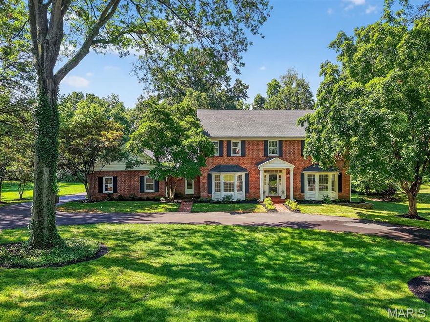 Hidden away among the woods, yet conveniently located near the I-64/270 interchange, is this custom 2-story brick colonial nestled on over 1 acre of land in an exclusive neighborhood of estate homes. Peaceful privacy awaits with mature woods behind the home keeping the world at bay. Recent updates include the kitchen with quartz counters, soft-close cabinets, and stainless steel Kitchenaid appliances, including a gas cooktop and wall ovens. The main level has 3 separate gathering spaces for everyone's comfort...the family room with rich wood built-ins & a wet bar, the hearth room tucked in the back wing of the home, and the living room with French door privacy...and all 3 rooms have gas fireplaces. Share meals in the sunny breakfast room or the beautiful formal dining room with custom trim details. Luxurious primary suite has a walk-in closet with organizer and updated private bath with dual sinks and frameless glass shower. All 4 bedrooms have walk-in closets and updated flooring. Finished lower level rec room is a great place to invite family and friends, along with a powder room & home office. Over 4,000 square feet of living space in total. Located in the heart of  Town & Country with easy access to everything, including 3 hospitals, fun shopping, wonderful dining and every convenience. Served by Parkway (West High) Schools. Exceptional opportunity...prime location. See it today!