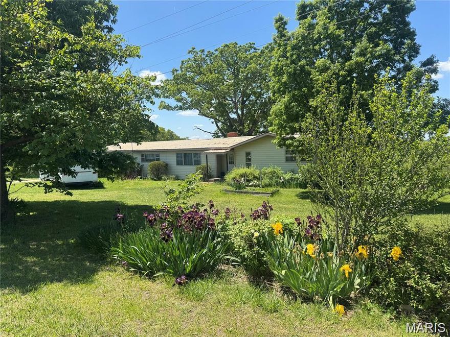 CHARMING 3 BEDROOM HOME ON 5 ACRES WITH A WORKSHOP! Located just a mile from city limits on the Mother Road of Route 66. This property features over 1400 sq ft of living space. Among the improvements, you will find a newer metal roof, an updated HVAC system, and laminated flooring throughout the home. The beautiful land includes great spots for your Garden. THE HOUSE IS COMFORTABLE & boasts three bedrooms, one bath, TWO LIVING AREAS, and a storm shelter/storage area in the basement. The family area features a rustic fireplace for those cozy winter evenings. You'll love the PICTURESQUE VIEWS from the kitchen window, which overlooks your backyard of the neighboring farm, with fields, a creek, and wildlife, including deer and turkey. Additionally, the property offers visibility to I-44 and strong potential for your new business, and is conveniently located near hospitals, stores, and amenities. More land available-