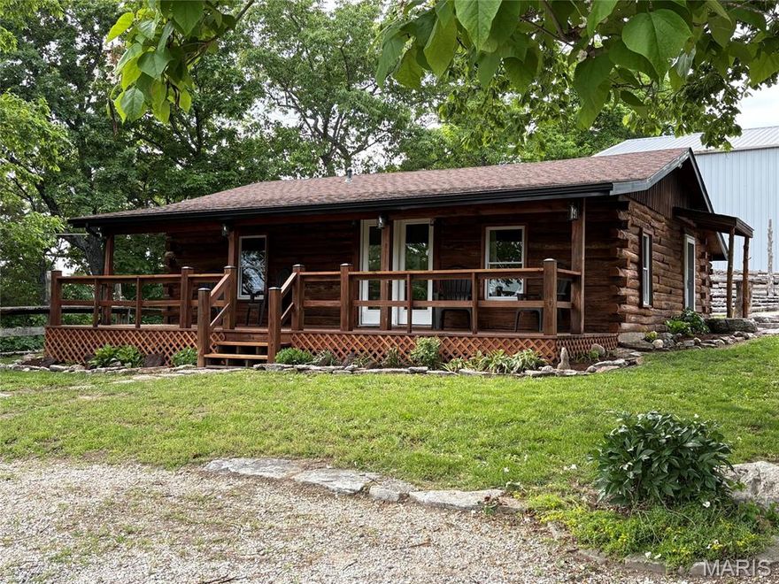Cozy lakefront Log cabin at Pinnacle Lake. Whether it's the lake, the sunsets, or just watching the clouds roll in over the neighboring hillsides, the views from this property will leave you breathless. This home is loaded with features and updates that include, open floor plan, modified coffer ceiling with recessed lighting, newer fans and fixtures, updated kitchen boasting huge center island with tons of storage, and a remodeled bath. Outside you will find a newer architectural shingled roof, new black facia and gutters, freshly stained exterior, new lighting, decorative landscaping, raised garden area, and a full length covered porch overlooking the lake. We're not done yet, behind the home is a large, detached garage with two overhead doors. Inside you can let your imagination run wild with the large open area, closed off heated workshop, separate bay, and an upstairs with additional rooms started. The possibilities are endless! All this sitting on over 3 acres!