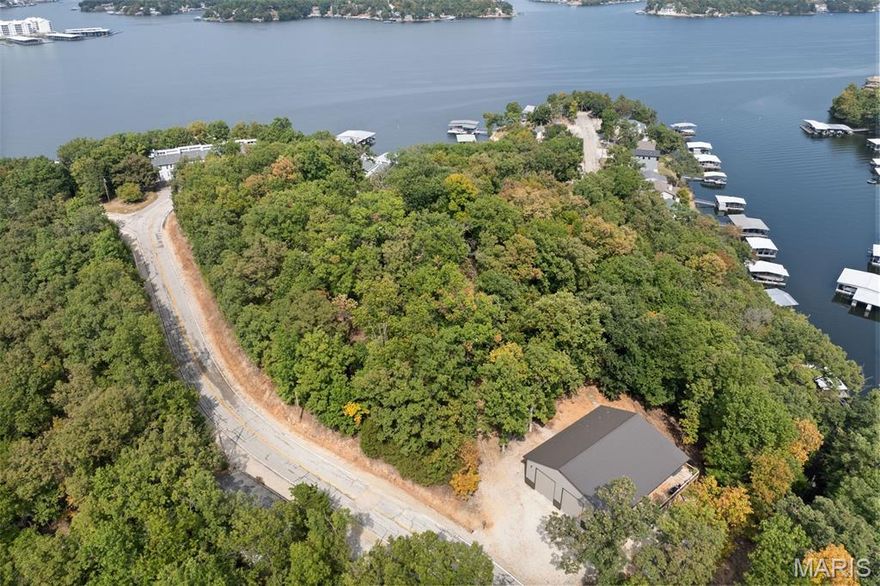 Rare opportunity to own a 50x50 quality-built 2022 Shouse while building your Dream Home on the hill in the Heart of Lake Ozark w/ NO HOA, just off MM 3! Nestled on 3.1 wooded acres with 2 acres having year round Lake Views. This partially furnished 2-bed/ 2-bath property perfectly blends privacy with convenience—minutes from shopping, dining, & entertainment. Offering 1,280 sq. ft. of beautifully finished living space & 1,220 sq. ft. of heated shop space, there's plenty of room for RVs, boats, vehicles, or even a home-based business. Interior highlights include an open floor plan, custom cabinetry, granite countertops, stainless steel appliances, LVP flooring, & R-30 insulation for year-round comfort. Enjoy the outdoors with a 75 sq. ft. open deck & a 330 sq. ft. screened-in deck overlooking the peaceful woods. The heated shop is a dream—featuring two 14' garage doors, two 50-amp RV hookups (inside & outside), an RV dump station, & a water softener. This versatile property combines modern living with endless storage, workspace possibilities & Potential Rental Income. A true one-of-a-kind find at Lake of the Ozarks—don't miss your chance to make it yours!