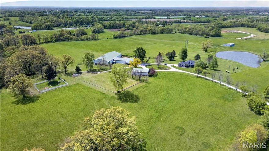 This is a one-of-a-kind EQUESTRIAN PROPERTY on private 38.11+/- acre LEVEL/GENTLY ROLLING lot in Elsberry with a CHARMING CUSTOM RANCH HOME W/2-CAR ATTACHED GARAGE, EXQUISITE BARN W/6 STALLS, INDOOR RIDING ARENA, RV/HORSE TRAILER CARPORT, OUT BUILDING, OUTDOOR RIDING ARENA, FENCED PASTURES, HIGH YIELD HAY FIELDS & a STOCKED POND! 3,266+/- SqFt, 3 bedroom, 3 full bath home. Quaint covered front porch greets you as you step inside the entry foyer. Spacious living room boasts a wood flooring, brick wood burning fireplace w/raised hearth, built-in custom bookcases, 13’+/- vaulted ceiling, walk-out to deck & wall of windows w/plantation shutters allowing plenty of natural light. Open, eat-in kitchen with custom cabinetry, Cambria Quartz countertops, tile backsplash, breakfast area & NEW Samsung Bespoke refrigerator w/pull-out freezer. Primary suite features recessed lighting, carpet, sitting area overlooking the beautiful/peaceful sprawling backyard & pond, walk-out to deck, & bath boasting double sink vanity w/Cambria Quartz, shower, jet tub & large walk-in closet. Two additional bedrooms feature spacious closets, carpet & share hall full bath. Laundry room & dining room completes the main level. Walk-out, lower level extends living quarters that flaunts a large rec room, office, exercise room, bonus room, full bath & large storage room for an abundant amount of storage. Within the Elsberry School District & easy access (4.5 miles) to HWY 61 (future I-64). SCHEDULE YOUR SHOWING TODAY!