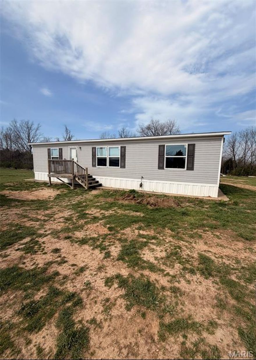 On the edge of town situated on almost 5 acres is this manufactured home that was built in 2020. 3 Bed, 2-bath will several sheds for storage and a spacious shop perfect for projects and extra storage. This property has it all!