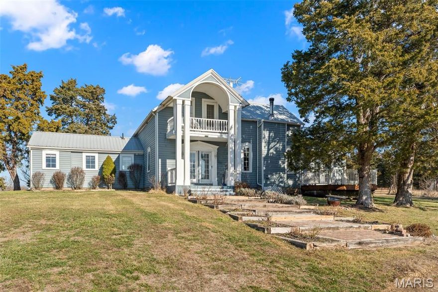 NEW PRICE! MUST SEE THE INSIDE OF THE HOME & OUTBUILDING! This charming two-story farmhouse was built in the late 1800 to early1900 with additional add-ons along the way situated on over 40+/- acres picturesque land, from the home there are beautiful breathtaking views in every directions. The home features high ceilings, spacious rooms, some original hard wood floors and tongue & groove ceilings making it both inviting and comfortable. The main floor includes a cozy eat-in kitchen with English cabinetry and granite countertops,  separate dining room, great room with a wood-burning fireplace surrounded with stacked rock, perfect for warming the home on chilly nights. A cheerful family room that leads to the deck. Retreat to the primary bedroom suite featuring customed designed closets, soaking tub, separate shower, and dual sinks. Laundry room with half-bath and a welcoming mud room. Dual staircase take your pick to the upper level finding you three additional bedrooms, one serving as another primary suite with bath, two of the bedrooms open to balconies to capture the stunning views. The outdoors features four-car detached garage, large metal building with electric, concrete, office or workshop with half bath. 2 ponds on the property. Great for farming or horses plenty of pasture and woods or unwind and simply relax in the serene environment. Don't miss your chance to view, call today.