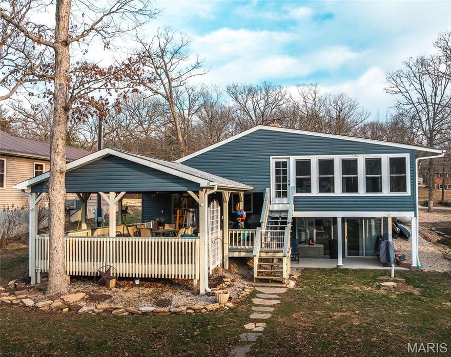 This house makes LAKE LIFE a breeze! Newer dock and lift and a level walk to the water make lake life easy! Situated close to end of cove 7, you can easily swim right off the dock or launch kayaks and canoes. The main floor includes a HUGE eat-in kitchen with all the counter and pantry space you need to feed your crowd. Also on this level is your primary suite with solid surface vanity, bidet, walk in shower and walk in closet. A large laundry/storage room is on this level as well. From the kitchen, the sliding glass doors lead to a large, covered deck overlooking a fire pit and the lake. Enjoy the lower level wood burning fireplace in the living room. This level also features LOTS of storage, a half bath and walks out to the yard. The upper level has a full bath and 3 nice sized bedrooms. One bedroom has a bonus room withwindows all around so guests and family can enjoy the view and stairs to exit to yard. The 3 car detached garage has space for your vehicles, golf cart and lake toys. Situated near the end of a cove, there is still plenty of water depth, yet it is easy to swim, float or fish right off your own dock.  The house includes many updates and upgrades incuding granite counters, commercial grade flooring and top of the line appliances. Indian Lake is 326 (+/-) acres and allows for boating, fishing, skiing, tubing, swimming, kayaking and more! Community has full service marina, beach/playground area, pickleball/tennis court (recently refurbished), basketball court and volleyball area. The community center hosts a variety of activities including potlucks, bingo, trivia nights, poker runs and other events. It can also be rented for private events.