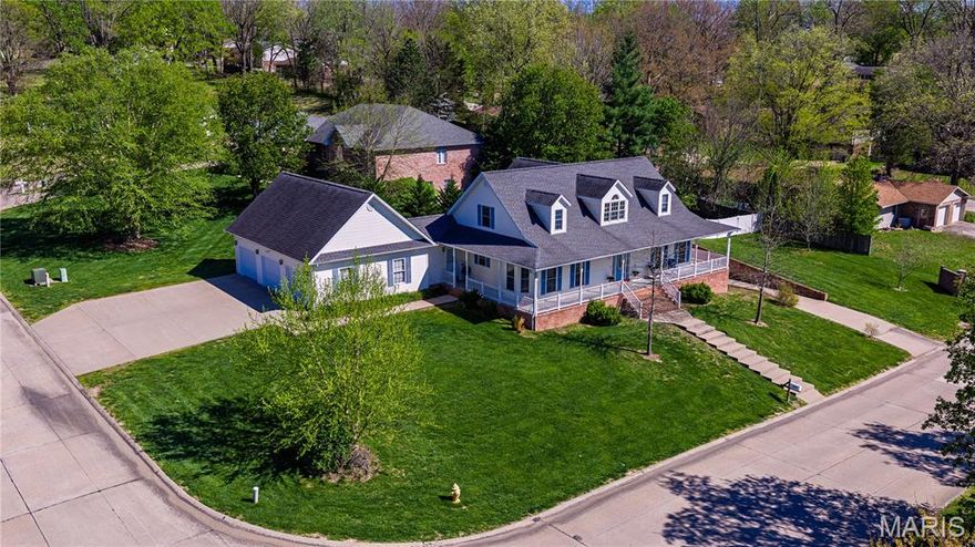 This one checks all your boxes for both interior space, outdoor living, and garage capacity.  The entrance foyer leads to an open stairway and the impressive Great Room with a wet bar, fireplace and mantel flanked by large windows, and a soaring 2-story ceiling.  The kitchen is a cook's dream!  Featuring an island with prep sink, an abundance of custom white cabinetry with black granite countertops, double ovens, and a breakfast area.  The formal dining room can accommodate a table for 12, and a hutch and buffet.  There are 2 ML bedrooms including the primary ensuite, with gorgeous dark wood flooring, a walk-in closet and fabulous bath. The upper level includes 2 additional bedrooms and another full bathroom.  Downstairs you'll find a family room with another fireplace, and built-in home theater speakers.  Additionally there is a craft room, sleeping area and full bathroom, a cedar closet that is plumbed for a kitchenette, a workspace, and a separate garage with its own entrance.  Could be a great MIL suite!  Located on a corner lot in Wyandotte Acres the home boasts a side entrance 3 car garage.  Outside you can enjoy your morning coffee, or evening cocktail from the wraparound front porch, or the expansive deck in the back, surrounded by white vinyl privacy fencing.  There is so much to love here!