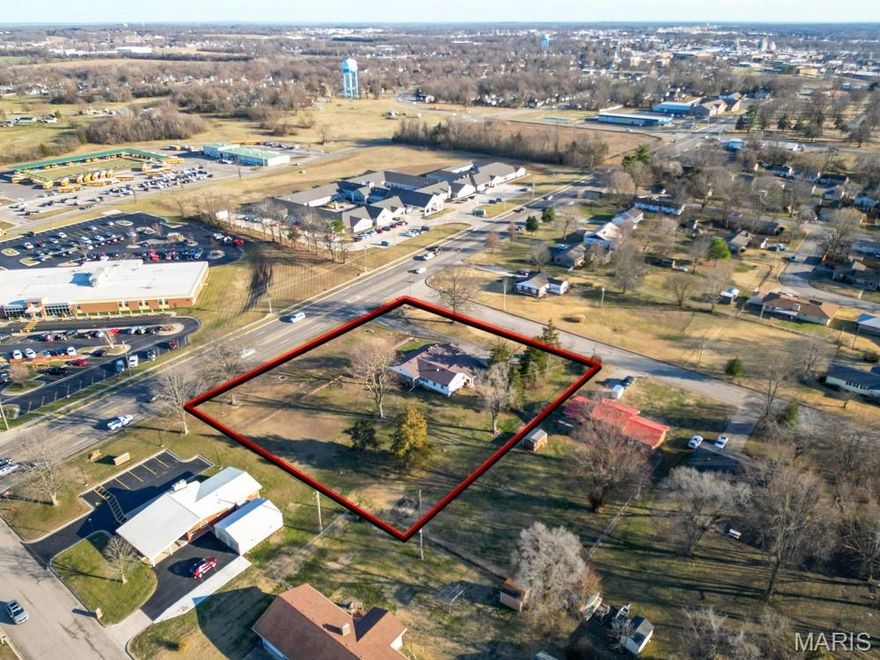 RARE COMMERCIAL OPPORTUNITY WITH HIGH VISIBILITY AND VERSATILE USE POTENTIAL! Situated on approximately 1.5 acres with excellent highway frontage, this well-maintained property offers outstanding exposure and accessibility, making it ideal for a variety of commercial or mixed-use applications. The existing 3-bedroom, 2-bath brick structure provides a solid, adaptable footprint that can be easily converted to office, retail, or service-based use, while still accommodating residential occupancy if desired. The building features multiple spacious interior areas suitable for private offices, conference rooms, or customer-facing spaces. A central living area with a fireplace and built-in shelving creates a natural focal point, ideal for a reception area or collaborative workspace. Large windows throughout the property allow for abundant natural light, enhancing the overall professional atmosphere and reducing the need for artificial lighting during business hours. Exterior features include a generous lot with room for expansion, additional parking, or outdoor business use. The fenced portion of the property adds security and flexibility for storage or designated activity areas. With strong curb appeal, durable construction, and a highly functional layout, this property presents an exceptional opportunity for investors, business owners, or developers seeking a high-visibility location with immediate usability and long-term potential.