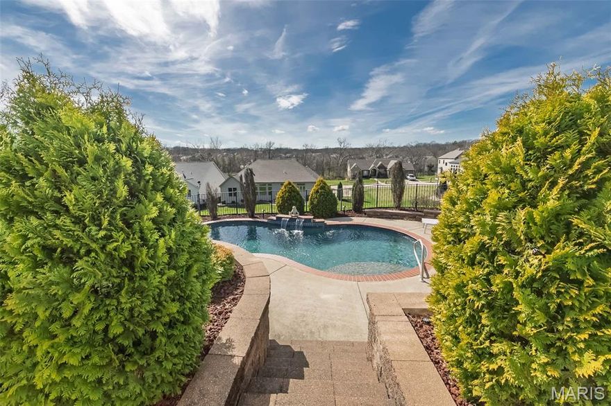 Discover refined living in this exquiste ranch showcasing high-end luxury finishes and a layout perfect for entertaining in sought-after East Hampton Woods. A side-entry 3-car garage, brick and stone facade, and manicured landscaping set the tone, while inside, soaring ceilings, arched doorways, and hardwood floors flow through sunlit spaces anchored by wood beams and a cozy gas fireplace. The chef’s kitchen impresses with a center island, granite countertops, and a custom walk-in pantry, a breakfast room opens to a large composite deck.  The great room has with a stunning elevated view overlooking the backyard retreat, offering perfect sunset vistas and sightlines that stretch for miles. A dedicated main-floor office offers true work-from-home convenience, or convert to an additional bedroom.  Main-floor laundry for everyday ease. The primary suite is a sanctuary with coffered ceilings, a custom walk-in closet, a spacious spa bath featuring dual sinks, a jetted tub, and a huge shower. An additional main-floor bedroom and full bath provide ideal flexibility.
Head down to the lower-level entertainer’s paradise—a sprawling rec room with wet bar, a separate media room, and another bedroom and full bath—perfect for game days, movie nights, and long-stay visitors. Step outside to your private, resort-style backyard oasis: a sparkling, tranquil pool surrounded by lush landscaping—ideal for quiet mornings or weekend gatherings. This is the one—style, substance, and a spectacular setting.