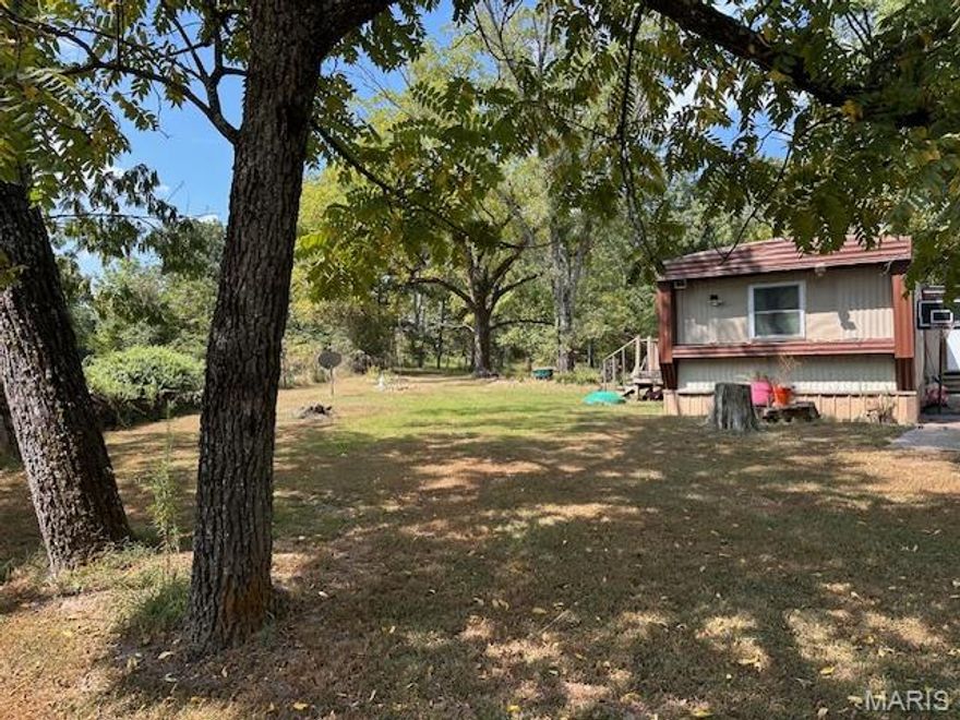 Country Living on 6.81 acres m/l within a mile to public access of the Upper Jack's Fork River for swimming, fishing, or kayaking. This property offers two mobile homes with a woven wire fenced in yard, lots of mature walnut trees, misc. outbuildings, fruit trees and lots of room for the kids, family, or pets to roam with NO RESTRICTIONS. First home has two bedrooms, two baths with central ac/central propane heat, built in laundry room with storage and in good condition. 2nd mobile home is three bedrooms, 1.5 bath and needs a little love, but the structure is strong. Old Home on property has no value. Property has two misc. outbuildings, old barn that has electric hook up for a camper. Located within a few miles to Mtn. View, MO which has a hospital, Walmart, grocery store, restaurants, and lots of mom-and-pop shops for your shopping experience.