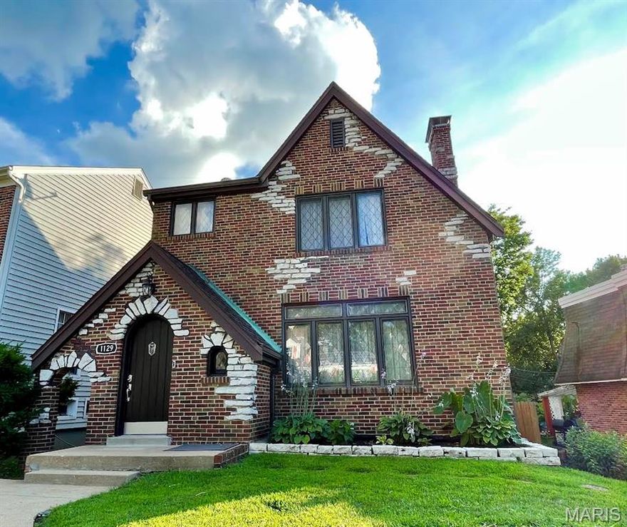 In the heart of Richmond Heights and the highly rated Clayton School District, this storybook 2.5 story Tudor blends timeless architecture with fresh modern flair. Arched doorways, hardwood floors, and two fireplaces set a warm, welcoming tone, while designer lighting and rich textures bring every room to life.  The chef’s kitchen wows with deep burgundy cabinetry, granite counters, and stainless appliances—open to the dining and sitting areas, perfect for cooking, conversation, and gatherings. Upstairs, you’ll find two spacious bedrooms plus a flexible top-floor retreat ideal as a 3rd bedroom, studio, home office, or guest space. Updated baths feature artful tilework, a copper vessel sink, and vintage-meets-modern style.  Enjoy morning coffee on the screened porch overlooking the fenced backyard oasis. From its arched-top front door to its new (2025) roof, this one-of-a-kind Tudor offers character, comfort, and convenience close to highways, parks, shops, and great restaurants.