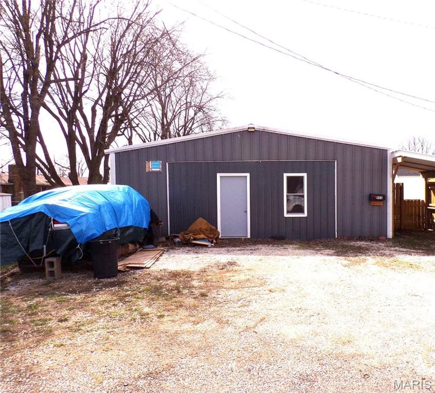 What a great starter home for a single person, a couple or even a senior wanting to size down and have everything on one level. This home is very functional as it offers a large, covered side entry   that leads into a large laundry area that has a large walk-in closet with a beautiful sliding barn style door. The living area has an open floor plan that offers a kitchen area, a dining area and a living room area. The spacious bathroom offers a large shower, a new vanity and some extra storage space. The kitchen area has new counter space and a large country sink. The entire living area has new flooring throughout. The garage is oversized and is currently being used as a storage area and a work area. This area can easily be reverted back to a pull in 1.5 garage as the garage door is still in place and functional. Call me for all details about this feature and the entire property. The home does have a double layer of insulation to make it very efficient. This property is one that needs to be personally viewed to fully appreciate the quality and the many possibilities that it has to offer. So again, call me and I will give you a private tour. Investors, are you looking for a great reasonable priced rental property to add to your portfolio, then look no further as this home is turnkey and ready for your clients. Call me today.