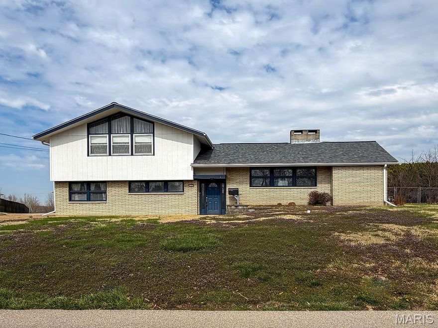Spacious Multi-Level Home in Festus School District!
Welcome to this well-maintained multi-level home offering approximately 2,600 sq ft of living space in the highly sought-after Festus School District! Built in 1961, this unique split-level design provides a functional layout with multiple living areas, perfect for everyday living and entertaining. Step inside to find a warm and inviting main level featuring beautiful hardwood flooring and a striking double-sided brick fireplace that adds charm and ambiance to multiple living spaces. The formal dining area offers classic appeal, while the kitchen provides ample cabinetry, updated stainless steel appliances, and generous workspace for the home chef. Enjoy year-round relaxation in the screened in sunroom/porch, where the fireplace creates a cozy atmosphere—ideal for entertaining or unwinding while overlooking the backyard. The covered patio with built in barbecue area extends your outdoor living options even further. Outside, you’ll appreciate the oversized driveway and detached 2-car garage, providing plenty of parking and storage. The spacious yard offers room to garden, play, or create your own outdoor oasis.