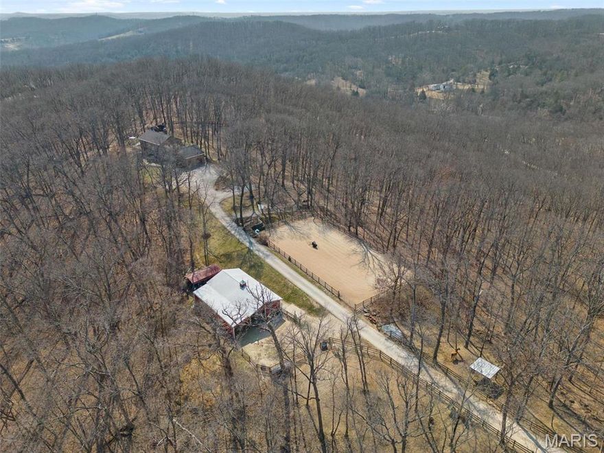 Calling all Outdoorsmen & Equestrians! Minutes to Greensfelder Park. Private 18 acre horse property. Glorious seclusion and A+Rockwood schools. Horse barn (4 stall or 3 + tack rm) w/ electric & water (frost proof yard hydrant). Riding arena +3 paddocks. Prime hunting, cleared shooting range & multiple trails for riding (dirt bike & horse). Wonderful in-ground pool. Large deck & screened patio. This spacious home offers 4 bedrms & 3.5 bath. Hardwood throughout the main. Living rm w/ sweeping property views & cozy stone fireplace. Beautiful custom kitchen + breakfast rm. Main Flr laundry/mudrm. Primary bedrm suite w/ fireplace & large bath. Finished walkout LL complete w/ rec room, full bath, kitchenette & California Closet queen murphy bed. Carport, shed, & playset included Geothermal HVAC & woodburning furnace. Imprvmts:Whole house generator 24kW+backup wiring for critical load generator (generator not incl).Closed septic system.Well pump. Inground pool improvements underway. Roof 2019 Additional Rooms: Mud Room