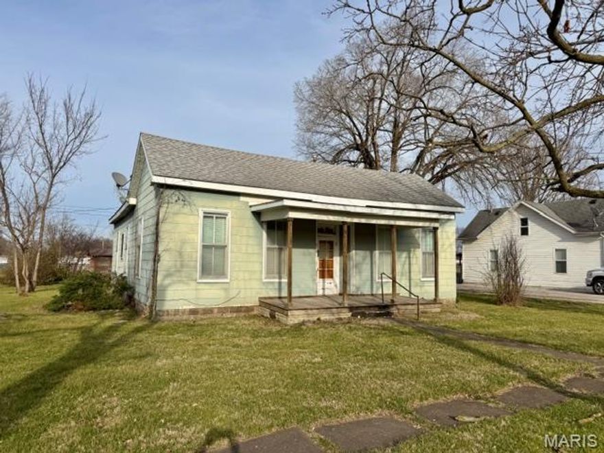 This two bedroom, 1 bath home sits on a corner lot and newer roof.  Large windows allow natural light to flow through home.  Wood floors in parts of home.  Covered front porch, detached garage.  Stove, washer, dryer and freezer convey with home.  Seller selling house as is.  Needs a little love, but could be refreshed in no time.