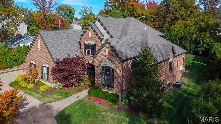 Spectacular custom built 1.5-story, by the award winning Dublen Homes, situated on a private .5-acre, cul-de-sac lot, in the heart of Olivette - Top Rated Ladue School District. This homebuyer’s dream has 4 bedrooms, 4.5 baths and over 7,800 sqft of living space. From the moment you walk through custom curved door, into the entry foyer, you will know you are home. This home boasts an open floor plan, designed for today’s living and entertaining. It is painted in stylish designer colors, has incredible custom moldings & woodwork throughout, and is truly move-in ready. Main floor features a separate formal dining room with gorgeous tiered tray ceiling, a fantastic office with a wall of built-in, and a large arched window, both with wainscoting & crown molding, a light filled living room, with a wall of windows, bringing the outside in, a granite clad gas fireplace with custom mantle, flanked by built-in bookcases with desk, a bar/Butler’s pantry, leading to the incredible gourmet chef’s eat-in kitchen, featuring an abundance of custom cabinetry, granite countertops & stone backsplash, large granite center island/breakfast bar, with sink and more storage, walk-in pantry, planning desk, and top of the line stainless steel appliances including Thermador 6-burner gas cooktop, double ovens, as well as an adjoining breakfast room. Stunning hearth room with vaulted wood clad ceiling & floor to ceiling stone gas fireplace, a lovely powder room, main floor laundry with custom cabinets & sink, and a mud room with built-in cubbies & coat closet. If that is not enough, the main floor primary retreat is grand & features a deep tray ceiling, large bay window, two custom organized closets, and a gorgeous granite-clad bathroom with dual vanities, air jetted whirlpool tub, large walk-in shower with dual shower heads & seat. Walk up the custom-made wood staircase, and you will find 3 additional, spacious bedrooms, all with walk-in closets, one en-suite, with its own full bath, and the other 2 sharing a Jack & Jill bath, an upstairs laundry closet with full-size stackable washer & dryer, and a fantastic bonus room with French doors, gas fireplace & built-in bookcases. The deep pour, professionally finished lower level is awesome featuring a large rec room with beautiful walk behind bar, and multiple seating areas, the 4th full bath, a sleeping area (possible 5th bedroom) and egress window, still leaving plenty of unfinished storage. Other features include zoned HVAC, beautiful walnut hardwood floors, in-ceiling speakers, recessed lighting, professional landscaping & outdoor lighting, irrigation & security systems, central vac, circular drive, and an oversized, side entry, 3-car attached garage. Relax outside on the expansive patio, with built-in firepit, or take a stroll through the park-like neighborhood. This home is perfect for entertaining family and friends!! Location could not be better – walking distant to Old Bonhomme Elementary School & Stacy Park, and just a 10-minute drive to premier restaurants, shops & art galleries - easy access to major highways.