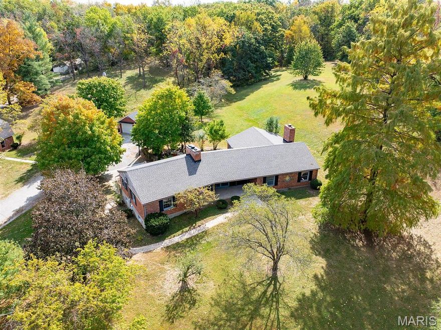 What a great combination! 13+ gorgeous acres, a 2600 sq. ft. brick raised ranch style home, a 35'x25' outbuilding, a tuck under garage plus a detached garage, a small barn for a horse or two, & peaceful "country" tranquility.... yet it is actually located in the city of Hannibal & so close to everything! Here's a few details: Quality steel beam construction! 3 bedrooms/2 full baths. Beautiful crown molding, heated floors, an entire row of closets along hallway, & 2 fireplaces that add to the ambience. The front entrance has an expansive covered porch. A private patio at rear entrance & massive living room w/wall of windows offer super views of deer as they romp & play. The outbuilding with loft for storage offers the perfect place to enjoy your hobbies, and/or store your grown-up style toys! Walking bridge leads to Gazebo for a different place to relax. Can this be your oasis and your forever home?