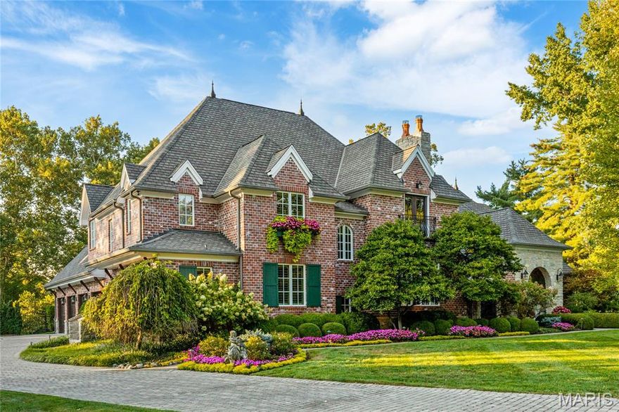 Wide plank hardwoods, timber beams & stone accent walls define the rustic elegance of this magnificent Dick Busch designed European-inspired Estate home. Impressive hardwood foyer leads to formal living room, dining room with 12’ timber beamed ceiling & stone fireplace & spectacular family room highlighted by floor-to-ceiling fireplace. Designer kitchen with custom cabinetry, commercial grade appliances, 9’ center island & butler’s pantry with convenient planning center adjoins gathering bar & wine room. Primary bedroom suite with beautifully appointed bath with shower spa offers an appealing retreat. Hardwood floors continue to the 2nd level with 4 additional bedrooms, 1 with ensuite bath & 2 with Jack n’ Jill bath. A 2nd staircase accesses guest suite & private study. Lower Level includes recreation room, game room, workout room & half bath. Situated on parklike 1.7-ac grounds with covered patio with fireplace, resort style pool, pool house & patio with pergola & full-height fireplace plus 4-car garage.