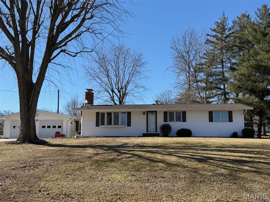 Don’t miss out on this beautiful home! This contemporary ranch-style home sits on nearly one acre of land and is located on a peaceful street on the edge of town. Inside you will find a spacious, thoughtfully updated interior designed for comfortable, everyday living. It is move-in ready and offers 3 bedrooms, 2 bathrooms, and over 1800 square feet of living space. The 2-car garage has a concrete driveway, and features a bonus room, which offers plenty of storage. The French doors from the dining room lead out onto a beautifully landscaped patio area. Roses and a variety of other perennials adorn the property.

This home has been lovingly cared for and thoughtfully remodeled with many special features. Examples include granite kitchen countertops with a Blanco granite sink, and a hidden, built-in spice rack. Additional features include a dishwasher that is only a few months old and has a 10-year warranty. You’ll also find a built-in ironing board with a laundry chute in the laundry room. In the primary bedroom, there are heated floors in the spacious en suite. An abundance of natural light can be found in the living room from windows on either side of the fireplace and the bay window. Beside the fireplace is a hidden wall fan for cooling. There is also a woodstove for another optional heating source.