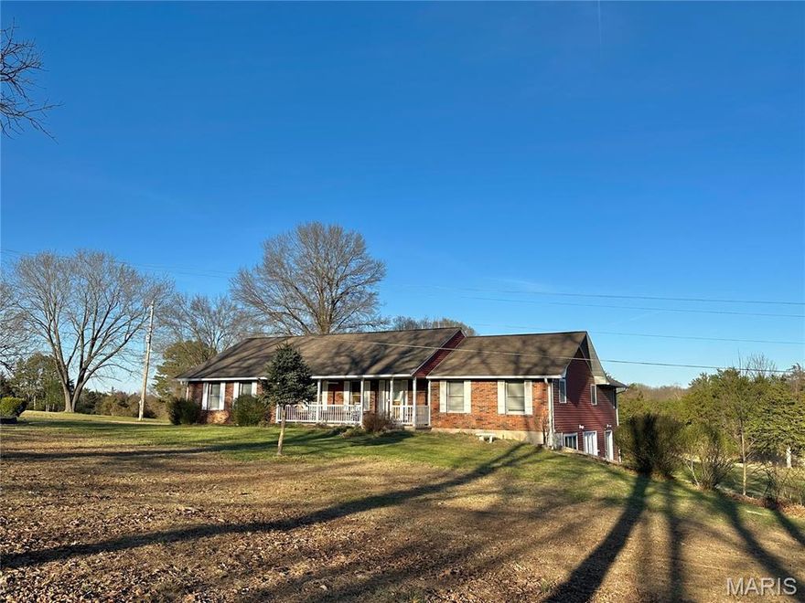 If you are looking for a large home with a country feel but still want to be inside the city limits, then this home is worth your time to look at. This 3.57 Acre parcel has its own well, concrete septic, beautiful mature oak trees, large front and back yard, a nice stocked pond and wet weather creek. 2554 sq. ft. on the main level with 3/4 finished basement. 4 bedrooms and 3 baths. 4th Bedroom in the basement is non-conforming with the possibility of a 5th. Two Utility rooms including one on the main floor and one in the basement. The kitchen has a beautiful custom set of cabinets with granite countertops. Plenty of extra kitchen storage with a pantry and multiple slide out features. Propane cooktop, double oven and Stainless Steel appliances. Center Island with built in features and a butcherblock countertop. Master Suite has a tub and separate shower with a double vanity and separate toilet. Large master bedroom closet with shelving. Large sunroom off of the kitchen/dining area. Small Office nook adjoining the master bedroom. Large family area in the basement with a small kitchen sink and storage. Full bathroom in the basement. Excess outside storage access on the basement level. Covered front porch and large composite back deck overlooking the back yard and pond. 21x 20 Two car attached garage with openers. Multi purpose garden/storage shed. Paved driveway and separate gravel entrance. Call  to schedule your private showing today!!