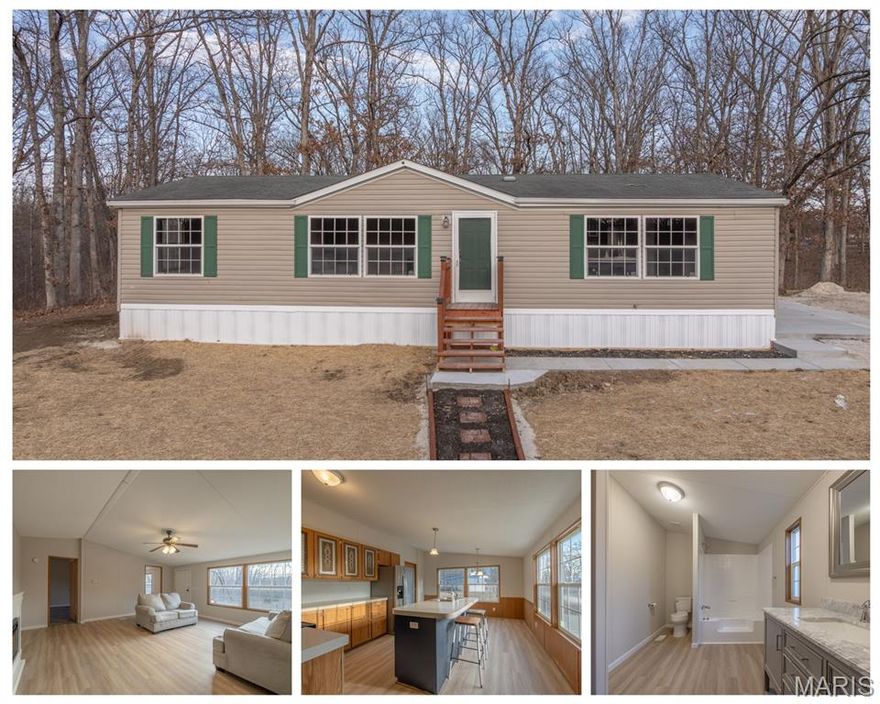 Own your own dirt and say goodbye to rent and lot rent forever! Permanently affixed manufactured home on a large .40 acre lot. Seller just had a new shingles installed on the roof for the new buyers.  This has been updated on the interior, 3 bedrooms 2 bathrooms, lovely kitchen and living room. Large living room has an electric fireplace. Primary bedroom has massive ensuite with new vanity and nice layout. Main floor laundry area with kitchen is open to dining area and also enjoys a lot of light. Public water and sewer. Backs to trees and has off road parking, a small deck and patio. Don't miss out on owning your own home!