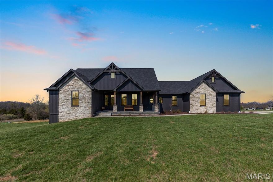 Stunning ranch-style home sitting on a 3 acre corner lot located in the sought after Indian Creek Farms subdivision in Foristell! Situated in a horse-friendly community and within the highly regarded Wentzville School District, this home boasts over 4,300 square feet of living space, 5 bedrooms, 3.5 bathrooms.

The front elevation features a welcoming covered front porch with a wood plank ceiling and leads to the double front doors. The front door opens to the entry foyer which features luxury vinyl plank floors that flow throughout most of the main level, and opens to the formal dining room and great room. The great room features soaring 11-foot ceilings with wood beams, a wall of windows, a stone gas fireplace, and opens to the kitchen.

The kitchen boasts granite countertops, 42 inch custom cabinetry, 2 tone cabinetry, granite backsplash, huge center island with marble countertops, stainless steel appliances, ZLINE gas range and ZLINE dishwasher, refrigerator which is included, pot filler, wood plank ceiling, crown molding, dining area, and a spacious 7x10 walk-in pantry with granite countertops, a wine fridge, and shelving.

The primary bedroom features a vaulted ceiling and a luxurious bathroom with a dual vanity, quartz countertops, tile floors, zero-entry walk-in shower with a tile surround, water closet with a pocket door, and his & hers closets. Two bedrooms, each with spacious walk-in closets, a powder room, full hall bathroom, and laundry room with a utility sink and custom cabinetry complete the main level.

The walkout lower level was finished in 2023 and boasts a huge recreation room which is wired for surround sound and has a plumbing rough in to add a wet bar, a game/entertainment area, an office, spa/storage room, 2 additional bedrooms, new full bathroom (2026), and ample storage space. The lower level offers a bright, airy feel with abundant natural light.

Other highlights include: new septic system (2026), water softener, new water filtration system (2025), permanent Christmas lights, walk-in closets in main level bedrooms, and a side-entry 3 car garage which is fully dry walled and has attached shelving.

Relax outside on the side concrete patio or on the screened in back porch with stamped concrete, a wood plank ceiling, ceiling fan, and enjoy the view of the 3 acre lot. The backyard also features fruit trees, irrigated garden boxes, and an attached swing set and hammock—perfect for enjoying peaceful sunsets and outdoor living.

Location could not be better – close to major highways, restaurants, shops, schools, and walking distance to Indian Camp Creek Park!