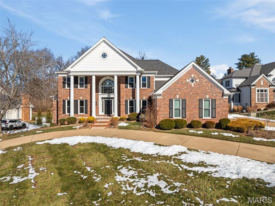 Welcome to 14342 Manderleigh Woods Drive — a beautifully crafted all-brick colonial estate tucked away in one of the most desirable enclaves in Town & Country. This original-owner home blends timeless architecture with modern comfort, set on a spacious, tree-lined lot that delivers exceptional privacy.
Inside, you’ll find over 6,150 square feet of impeccably maintained living space designed for both everyday living and effortless entertaining. The expansive updated kitchen serves as the heart of the home, showcasing premium cabinetry, hardwood floors, marble countertops, a walk-in pantry, and Viking Professional appliances — all opening seamlessly to the dining and hearth rooms with vaulted ceilings, plantation shutters, and a gas fireplace.
The main-level primary suite offers a true private retreat with two walk-in closets, double vanity, jetted tub, separate shower, and private water closet. Upstairs includes a large ensuite bedroom with private bath and oversized walk-in closet, plus two additional bedrooms with walk-in closets and private vanities sharing a Jack-and-Jill style bath.
The finished walk-out lower level adds over 1,400 square feet of living space with floor-to-ceiling windows, full bath, gas fireplace, and a well-appointed wet bar with full refrigerator — ideal for entertaining, game days, or movie nights.
Outdoor living is just as impressive, with three patios, a quiet cul-de-sac setting, and wooded common ground behind the home providing a peaceful natural backdrop.
Major recent updates (within the past five years) include a new roof, gutters and downspouts, windows, water heater, and three HVAC systems — offering confidence and low-maintenance ownership for years to come.
Located in Manderleigh of Town & Country, just minutes from Hwy 141 and I-64, this home combines luxury, privacy, and accessibility near top schools, hospitals, shopping, and dining.