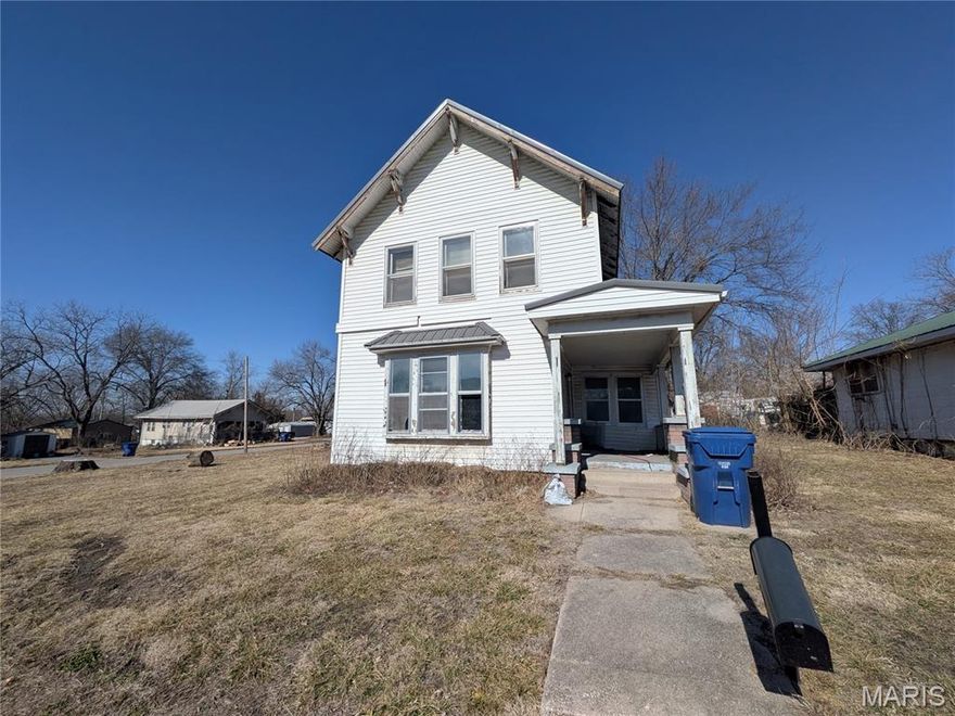 Located at 420 Smith St, this property showcases durable metal roofing and original interior woodwork. The two-story layout features baseboard heating and a new water heater. Inside, find character-rich hardwood floors and a flexible upstairs ready for your choice of flooring. The kitchen provides a blank canvas for personalized finishes. External features include a paved street frontage and a large storage shed fully wired for power. This residence offers an inviting opportunity to customize a space with solid bones and classic craftsmanship in the heart of Brookfield.
