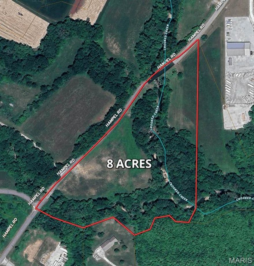 Positioned in a quiet, desirable corridor of Moscow Mills, this versatile 8 acre tract on Hampel Rd offers a blend of income potential, natural beauty, and future homesite appeal. Currently utilized as productive row crop ground, the property provides immediate return while presenting an exceptional opportunity for development.

With public water and sewer available and direct asphalt road frontage, the groundwork is in place for a seamless transition to a custom setting. Crooked Creek meanders through a portion of the property, enhancing the landscape with scenic character and attracting local wildlife, while a mix of open ground and scattered woods offer usability and privacy.

Zoned single-family and located within the highly regarded Troy R-III School District, this property is ideally suited for those seeking a private rural setting without sacrificing convenience. Just minutes from the amenities of Moscow Mills, yet tucked away in a quiet area, it strikes the perfect balance between accessibility and seclusion.

Property is located within a designated floodplain, offering fertile ground for agricultural use and contributing to the natural character of the landscape. Buyers to verify flood zone details, building requirements, and any applicable restrictions.

Whether you’re looking to build, invest, or hold income-producing land in a growing area of Lincoln County, this property presents a compelling opportunity with long-term upside.