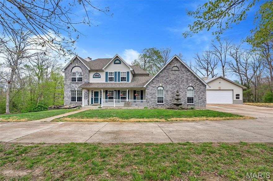 Tucked away on 3 peaceful acres in the desirable White Oak Trails subdivision, this beautifully updated and meticulously cared-for 4-bed, 3-bath traditional two-story offers the perfect blend of privacy, space, and modern comfort. The main level features a formal dining room, office, and a spacious family room with a gas fireplace and porcelain flooring. The kitchen and breakfast room flow together seamlessly, offering an open, welcoming layout ideal for everyday living, and include one of the home’s two Pella sliding doors—the second located in the walk-out basement. All kitchen appliances stay, and the home is equipped with a 3-stage water filtration system and water softener for added convenience.

Upstairs, you’ll find four generously sized bedrooms, including a primary suite with a walk-in closet and an updated bath. The walk-out lower level provides a massive unfinished space with 9-ft pour, egress window, roughed-in bath, and a wood-burning furnace, giving you both future expansion potential and an efficient supplemental heat source.

Outside, the property shines with a private, park-like setting, mature trees, and bright, colorful flowers that add charm and warmth as you approach. The impressive 30×40 outbuilding is exceptionally well-insulated—including the ceiling—and features a wood-burning stove plus a new Bosch mini-split system offering heat pump, AC, and dehumidification. Whether you need a workshop, hobby space, or climate-controlled storage, this setup is ready for anything. The oversized garage configuration at the home adds even more flexibility. With wooded surroundings and the peaceful feel of country living paired with the convenience of Francis Howell schools, this home truly has it all.