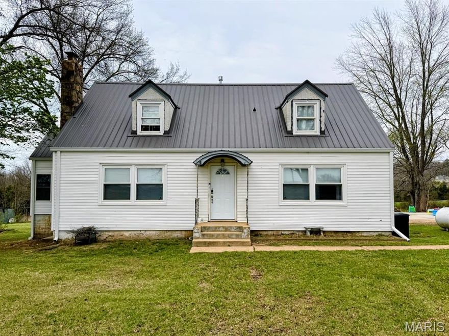 Charming 3-bedroom, 1.5-bath home on 2 acres with a classic farmhouse look, metal roof, and dormer windows. Recent 2025 updates include a new deck, new siding, new gutters, a new furnace, and other valuable improvements. The main level also features an additional room that can serve as a dedicated office or a fully conforming bedroom, along with a finished sunroom offering extra living space. The property provides open yard space and a barn ideal for livestock, storage, or projects. A great opportunity for country living with major upgrades already completed.