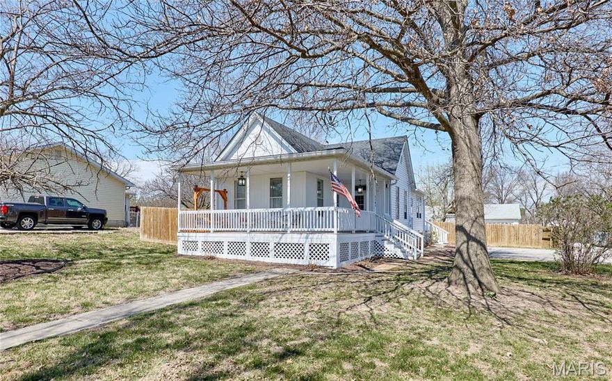 Modern character meets everyday functionality in this beautifully maintained home nestled in the heart of Troy. From the moment you arrive, the storybook wraparound front porch invites you to unwind, making it the perfect place to relax and take in peaceful sunset views. Situated on nearly half an acre, the fully fenced yard offers both privacy and plenty of space for children and pets to play freely. Inside, the home showcases timeless charm with tall ceilings, rich hardwood floors, and generously sized bedrooms that provide comfort and flexibility. The thoughtfully remodeled kitchen is a standout feature, boasting granite countertops, stylish cabinetry, and stainless steel appliances. A convenient breakfast bar and spacious pantry enhance both storage and everyday living. Just beyond, the backyard includes a storage shed—ideal for tools, hobbies, or seasonal items. The primary suite offers a private retreat, complete with a full bath, large closet, and a versatile sitting area that can easily serve as a home office or reading nook. All of this is complemented by a prime location just minutes from local shops, dining, and parks—giving you the perfect balance of tranquility and convenience.