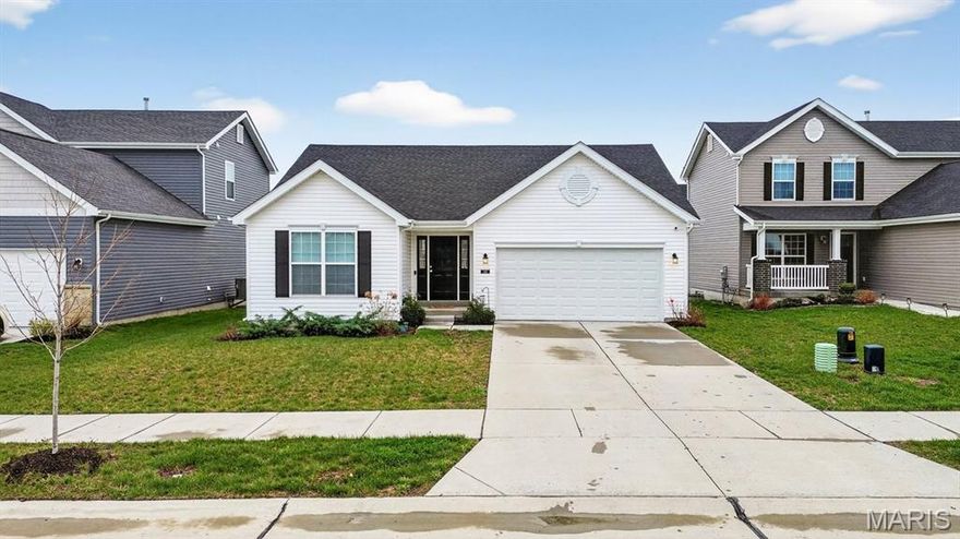 Move-in ready and built in 2023 by the original owners, this Aspen/Traditional II ranch in Charlestown Landing offers an open layout with vaulted ceilings, recessed lighting, ceiling fans, and a fireplace creating a comfortable main living space. The kitchen features granite countertops, 42” cabinetry, stainless steel appliances, and a large center island that opens to the dining and living areas. One of the three bedrooms is currently used as a sitting room, offering flexible use of space. The primary suite includes a spacious layout with a double vanity bath, and an additional full bath serves the remaining bedroom. The unfinished lower level includes a bath rough-in and offers opportunity for future finish. A sliding glass door leads to the newly added concrete patio overlooking the level backyard, providing great outdoor space. Located near a newly opened school and an area experiencing continued growth with new shopping, restaurants, and a Dierbergs currently under construction.