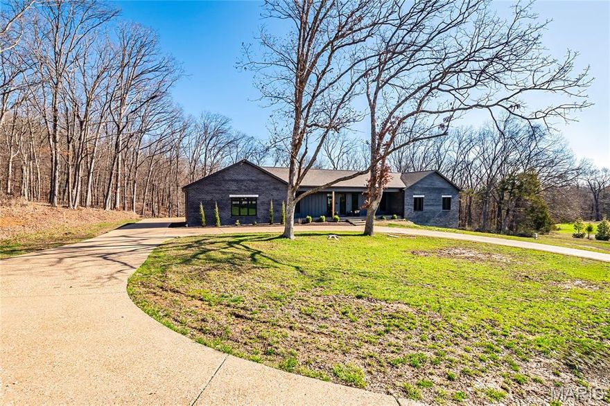 Stunning custom-built ranch home situated on 4.8 acres, just moments from Don Robinson State Park, with the park bordering part of the subdivision. This 4-bedroom, 3 full bath home offers quality craftsmanship and thoughtful design throughout.
The open floor plan features a spacious kitchen with a large island—perfect for entertaining—GE Café appliances, and Waypoint custom cabinetry. The laundry room also showcases custom cabinetry for added functionality , large walk in pantry with built in  cabinets .
Enjoy beautiful details including tongue-and-groove ceilings on the front porch, rear covered porch, and front bedroom, along with a wood-look stamped concrete front porch. The walk-out lower level includes a covered patio, rough-in for a future bath, and a large storage area under the front porch—ideal for a storm shelter or secure storage.
Interior finishes include Cali Bamboo flooring in all bedrooms, quality tile throughout, and custom bathroom vanities and showers. The home is built with Thermasteel exterior walls, Diamond Kote siding, an Aquasana whole-house water filtration system, and a striking Pinky’s Iron front door. The exterior features an exposed aggregate circle driveway and a 3-car rear-entry garage. A full bath off the garage offers flexibility as a dog wash station or zero-entry access for wheelchair convenience.
A rare blend of privacy, craftsmanship, and modern amenities—this is country living at its finest.