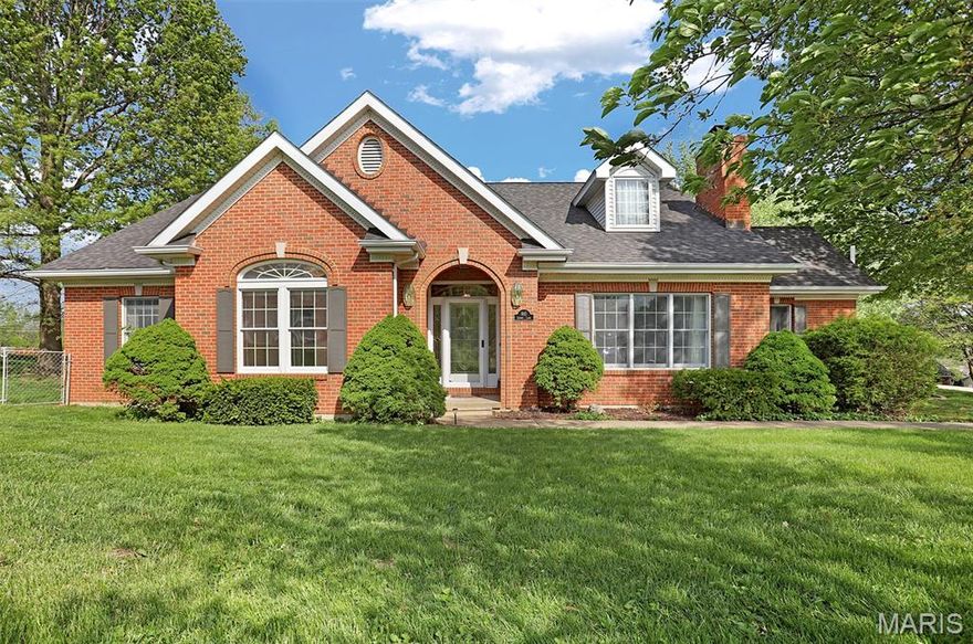 Beautiful, brick-front home on right under 3/4 of an acre with a 4-season room overlooking the beautiful backyard with mature trees. This attractive property is in great condition, originally constructed in 1991. It offers a lead glass front door, hardwood flooring and custom millwork. An open floor plan interior fosters an expansive and inviting environment throughout. The kitchen, a central element of the interior, offers an eat-in breakfast area and features stylish stone backsplash and updated appliances, complemented by a practical kitchen peninsula. Within the living room, a welcoming fireplace creates an inviting atmosphere. Beyond is the formal dining room. The primary bathroom offers the convenience and ease of a walk-in shower. Outside, residents can enjoy a quiet patio, an invigorating hot tub, and an outdoor dining area, all within fencing for privacy, creating a perfect setting for outdoor enjoyment. This property provides four bedrooms and 4.5 bathrooms, accommodating various familial needs. Downstairs is finished with an additional kitchen, family room, sleeping/office area and bath. This home has a 3-car garage with extra space for all your toys. Have all the convivences of in town living with privacy on a quiet street. This residence offers a distinguished living experience, thoughtfully designed for comfort and enjoyment.