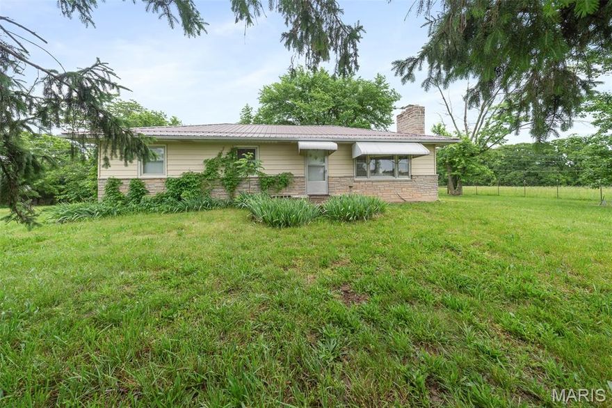 Charming country setting just minutes from Rolla! This 3 bedroom, 1.5 bathroom home sits on 3.27 acres m/l and offers the perfect blend of privacy and convenience. A welcoming living room features a cozy wood-burning fireplace and beautiful wood flooring that continues into the dining room. The kitchen boasts abundant cabinetry for all your storage needs, while the laundry room is conveniently located just off the kitchen. Three generous bedrooms and a full bathroom complete the main level. Downstairs, the unfinished walk-out basement includes a half bath and tuck-under garage, offering plenty of potential for additional living space, storage, or a workshop area. Property also features a detached 1-car garage/workshop. Don’t miss this opportunity to enjoy peaceful living with room to grow—schedule your private tour today!