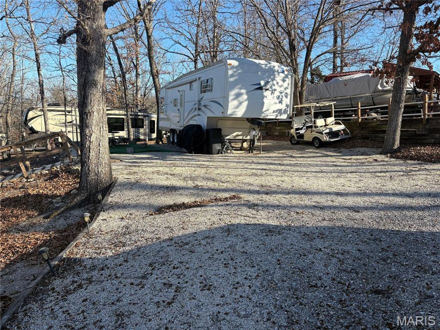 Looking for a summer get-away ? This full time camping lot in the gated community of Lake Perry is the total package. The lot is close to the community  beach and offers water, sewer, and electric hook ups. Included with the sale of the lot is a 32 ft Holiday fifth wheel camper and a 1997 Sylvan pontoon boat. Pack your bags and start enjoying summer right away!