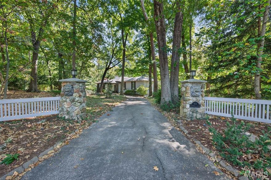 Nestled on a 3.4 acres, you'll fall in love with the wooded oasis and park-like retreat surrounded by towering trees and peaceful natural views. This multi-level residence blends casual sophistication with architectural interest, creating a warm and livable elegance rarely found in today’s market.

Soaring ceilings and a dramatic floor-to-ceiling stone fireplace define the great room—a space that captures light and nature through every window. Adjacent, a library features rich built-ins and a second fireplace, perfect for quiet evenings or creative inspiration. The spacious kitchen offers an inviting center island, breakfast nook, and easy flow to the deck—ideal for morning coffee and watching deer wander by.

The primary suite enjoys its own level of privacy just a few steps above the main floor, complete with a generous walk-in closet and spa-inspired bath. Two additional bedrooms with a Jack-and-Jill bath sit a few steps down, while the walk-out lower level expands your lifestyle with two more sleeping areas, a full bath, and a flexible recreation room framed by custom built-ins and walk-out access to the grounds.

With multiple outdoor terraces, a 3-car garage, and tranquil surroundings, this is an exceptional opportunity to experience nature and privacy within minutes of Clayton, Plaza Frontenac, and all Ladue conveniences.