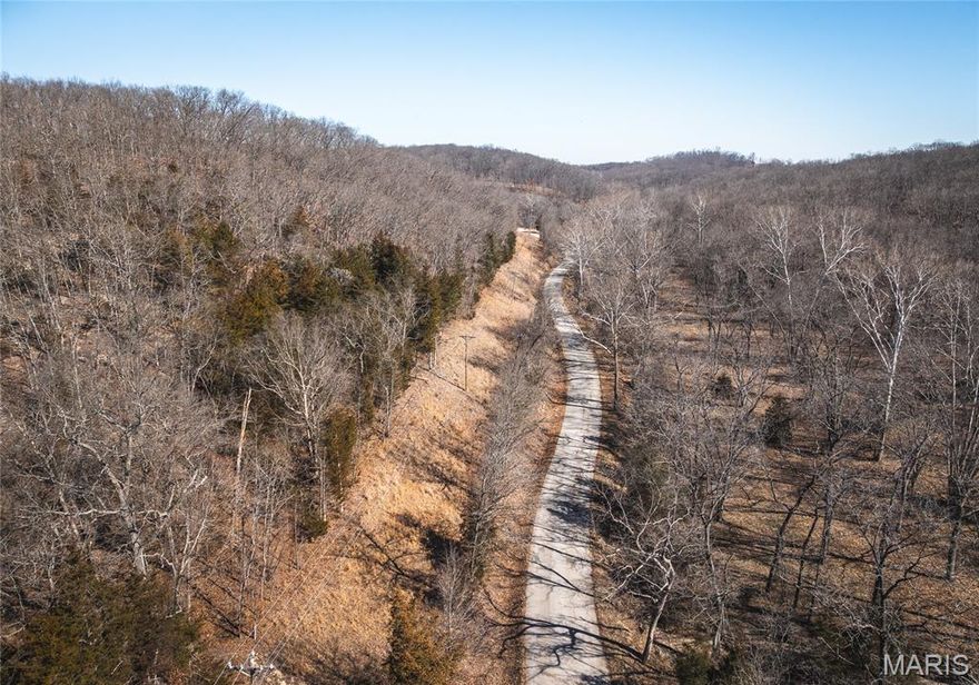 Discover the perfect blend of recreation, privacy, and lake living with this exceptional 27± acre tract in Sunrise Beach at the Lake of the Ozarks. Properties like this are becoming increasingly difficult to find—offering a diverse landscape, excellent hunting, and a beautiful setting to build your dream retreat.
The land truly has a little bit of everything. Rolling high ground with lake views and scenic ridges are covered in mature hardwood timber, while a wet weather creek winds through the property adding both character and a natural wildlife travel corridor. Towering oak trees produce an impressive acorn crop each fall, creating a reliable food source that keeps wildlife on the property year-round. The result is an incredibly productive hunting tract with abundant deer and turkey sign throughout the property. In addition to its recreational appeal, the property offers a build site with electric available along the east boundary and high-speed fiber internet accessible. Imagine building your home or cabin where you can enjoy a peaceful setting yet surrounded by all the lake life close by.
Conveniently located on a quiet dead-end hardtop road, the property offers both privacy and easy access. Within minutes you can enjoy everything the lake area has to offer including local restaurants, marinas, boat ramps, and shopping around Lake of the Ozarks and Sunrise Beach.
Whether you're searching for a hunting getaway, a private lake-area home site with no HOA, or a versatile tract with room to roam, this property is a great opportunity. Tracts like this don’t come along often in this area.