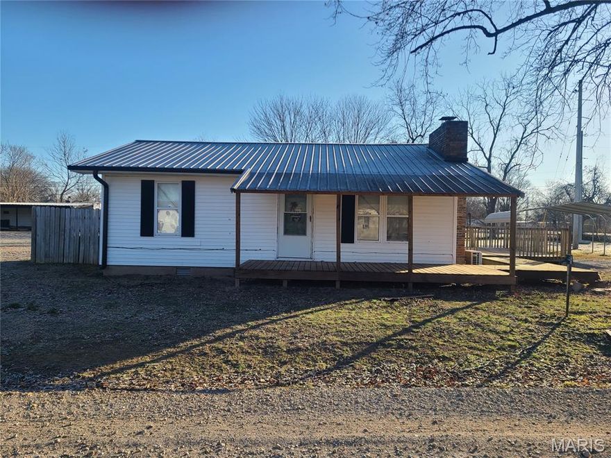 2 bedroom, 1 bath home offering 832 sq. feet of living space featuring an open floor plan, kitchen with island, mini-split heating cooling system, and wood burning fireplace. This property offers a large deck and a spacious lot for outdoor use and privacy. Home has been partially remodeled and needs finishing touches to make it your own. New kitchen sink and water heater are being installed.  2-car detached metal carport awning and 53 ft. storage trailer included.